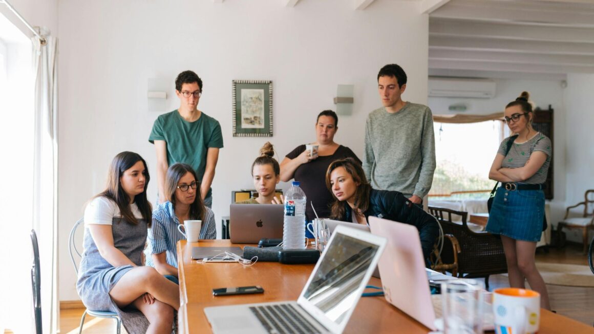 Team meeting around laptops at an office
