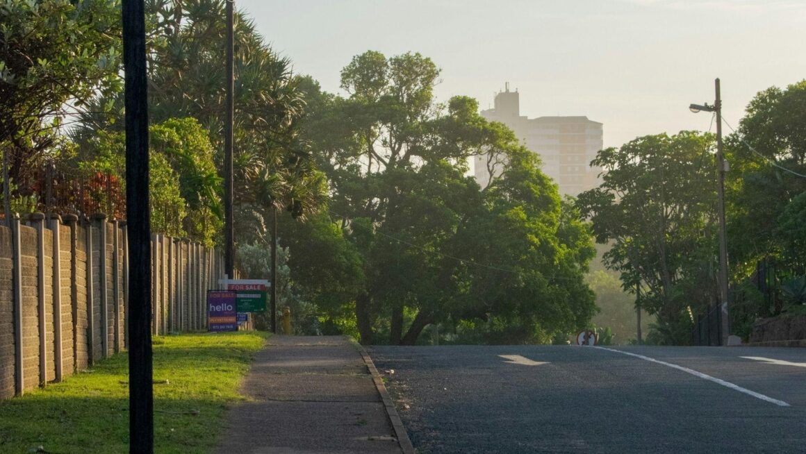 A quiet residential street at sunrise, representing a smooth and speedy home move.